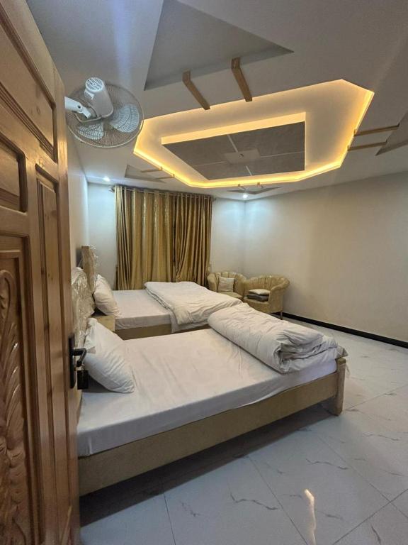 a bedroom with two beds in a room at Askari Lodges Murree in Murree
