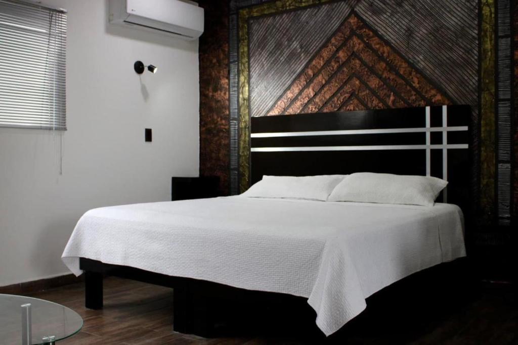 Ένα ή περισσότερα κρεβάτια σε δωμάτιο στο Hotel DLux