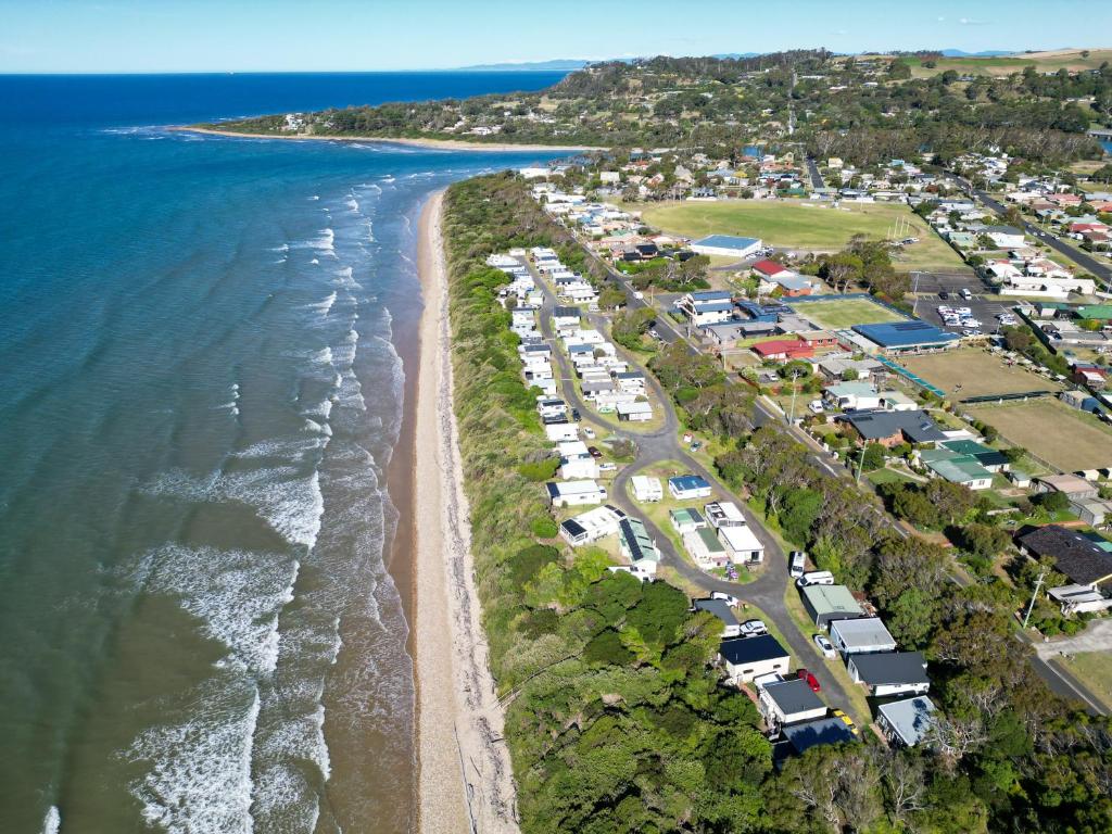 an aerial view of a beach with houses and the ocean at Turners Beach Holiday Cabin in Turners Beach