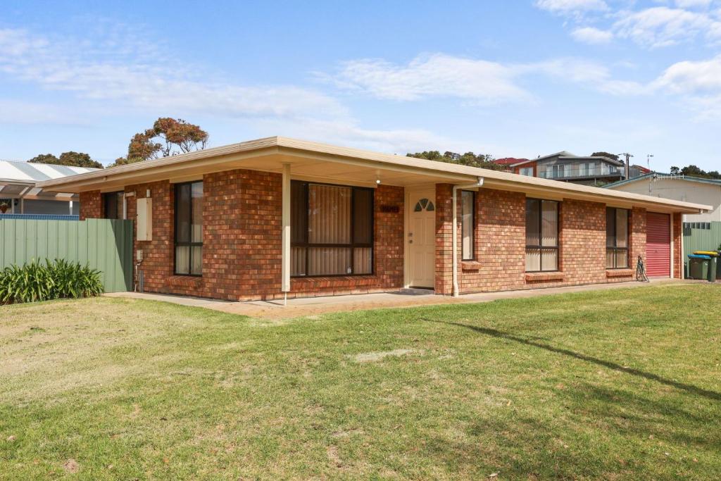 a brick house with a lawn in front of it at Pet Friendly in Port Elliot in Port Elliot