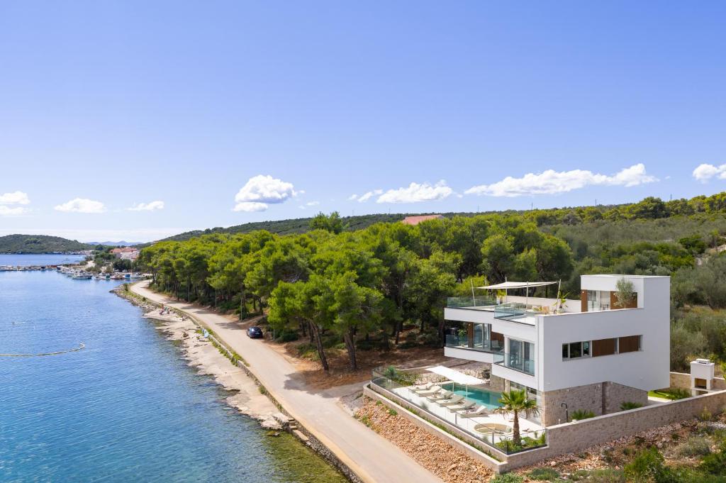 an aerial view of a house next to the water at Luxury villa Zara, first row to the sea! in Kali