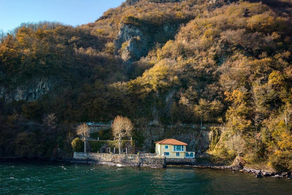 a house on a island in a body of water at Villa Melody by Aura Luxury Collection in Molino Nuovo