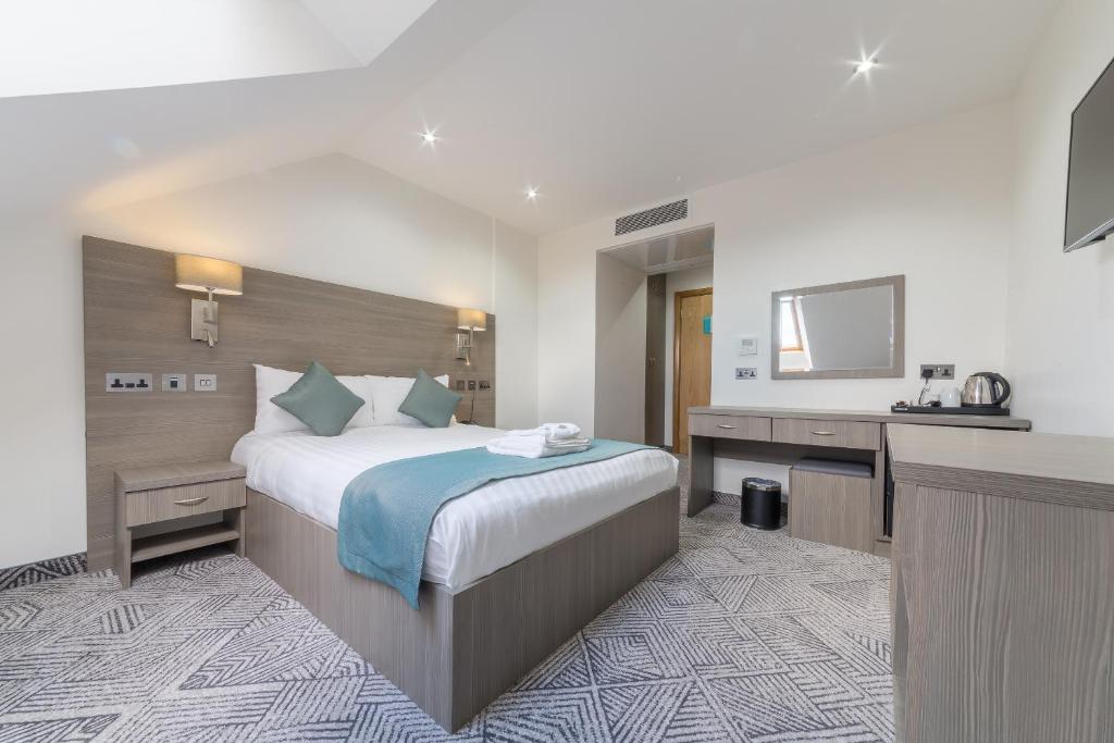 a hotel room with a large bed and a sink at The Lion & Key Hotel in London