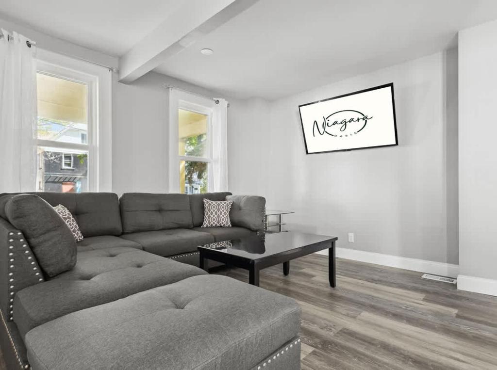 a living room with a couch and a table at 4BR Niagara Falls Home Free Parking WiFi in Niagara Falls