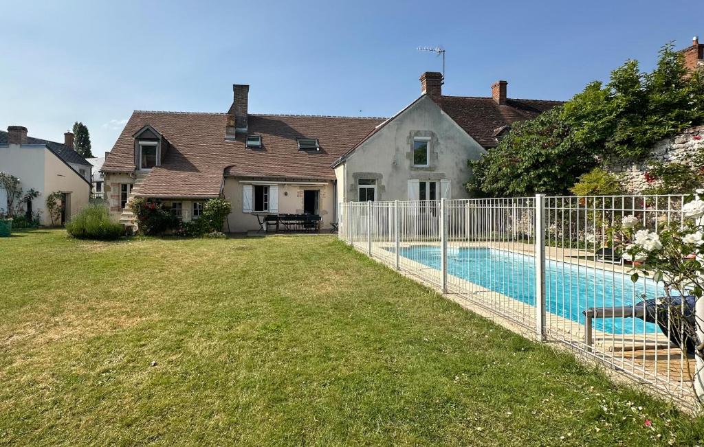a fence around a yard with a swimming pool at Beautiful Home In Ingrannes in Ingrannes