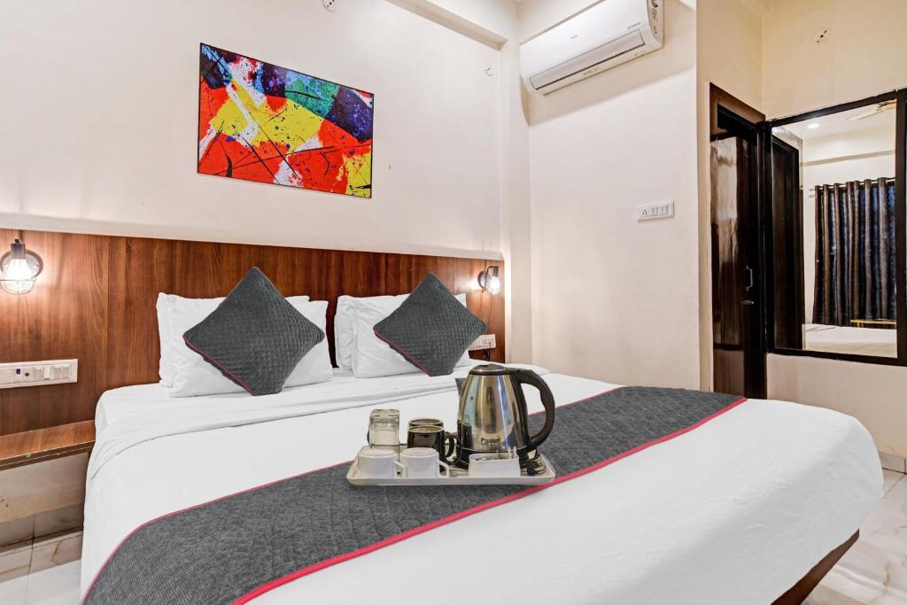 a hotel room with a bed with a blender on it at Super Townhouse Hotel O Benchmark in Indore