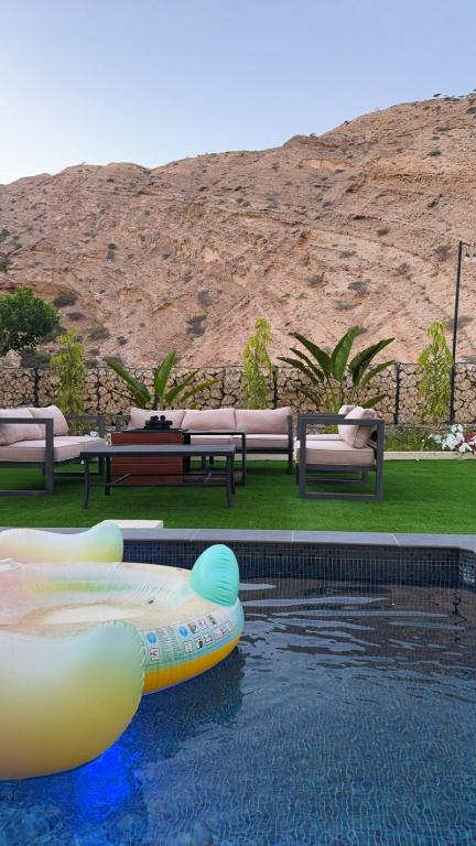 a pool with two inflatable tubes in the water at W muscat bay in Muscat