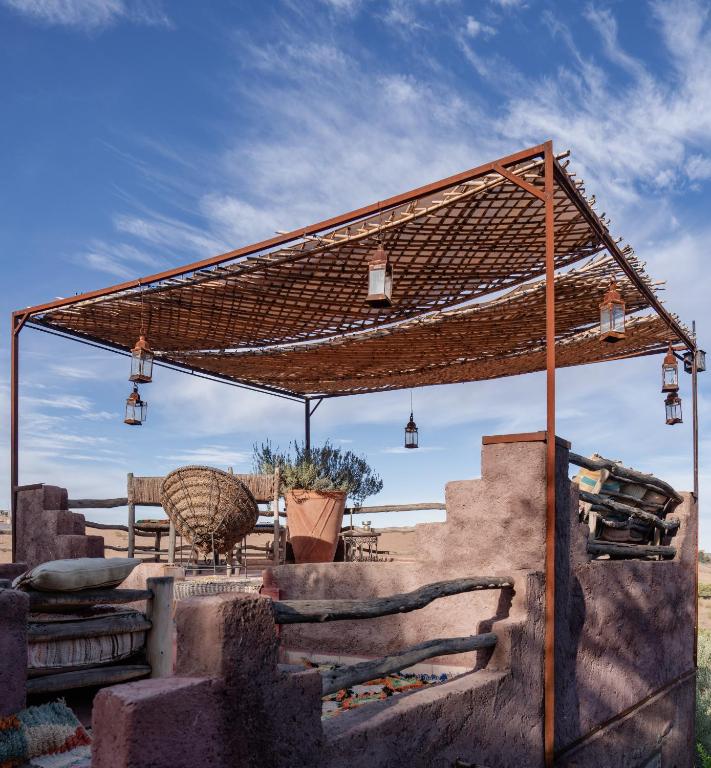 a pergola with lights on top of some stairs at Atlas Aura Hotel Ourika - Marrakech in Agadir nʼTafent