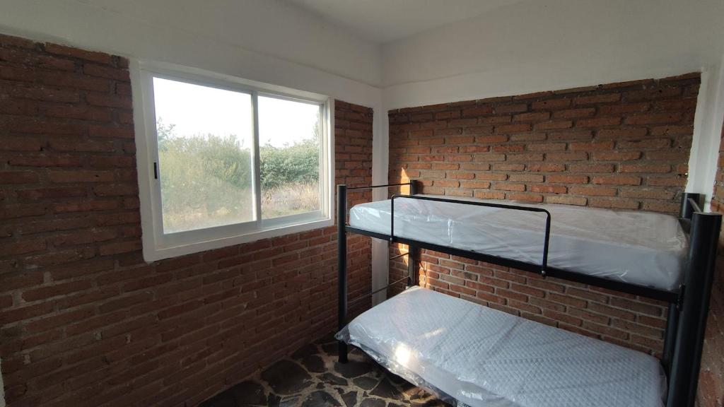 En eller flere senge i et værelse på Casa rural