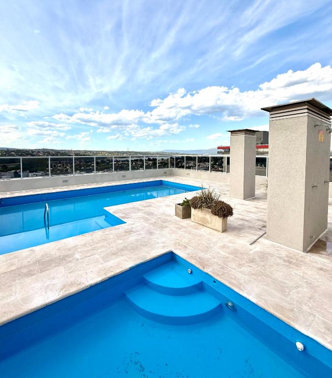 a swimming pool on the roof of a building at City Paz in Villa Carlos Paz