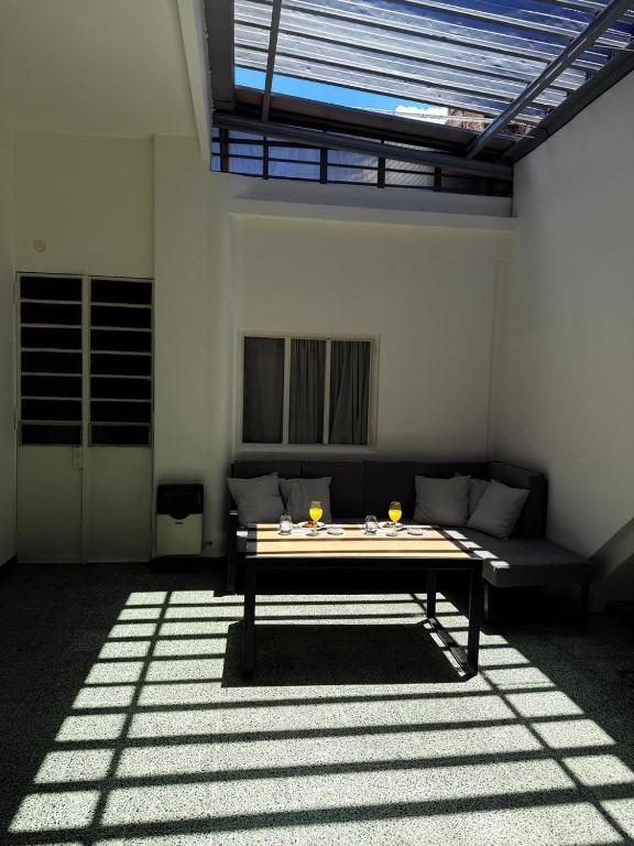 a living room with a table and a couch at The Marseille Oasis in La Porteña