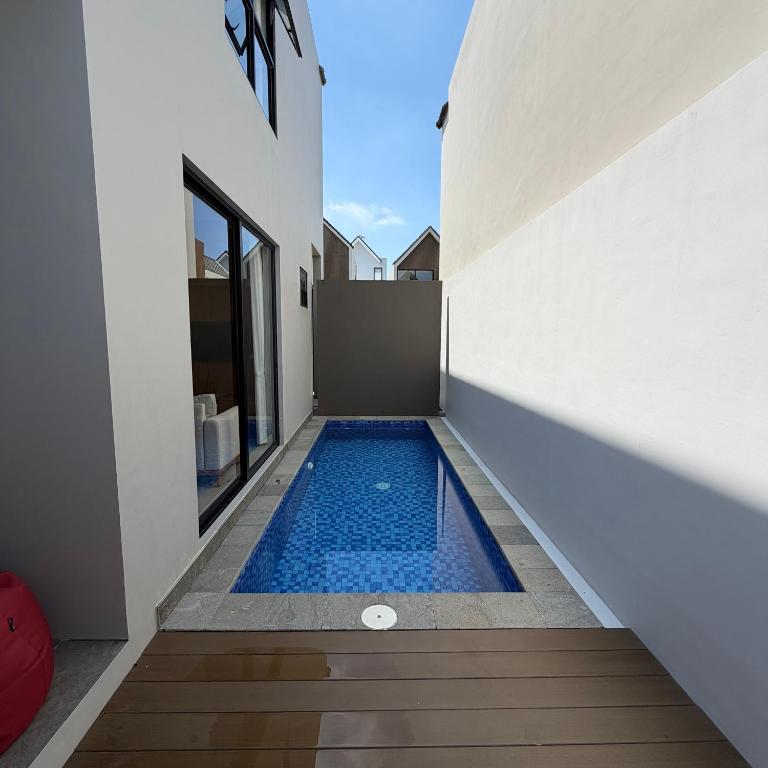 a swimming pool in the middle of a house at Elegant 3 bedroom Villa in Jimbaran