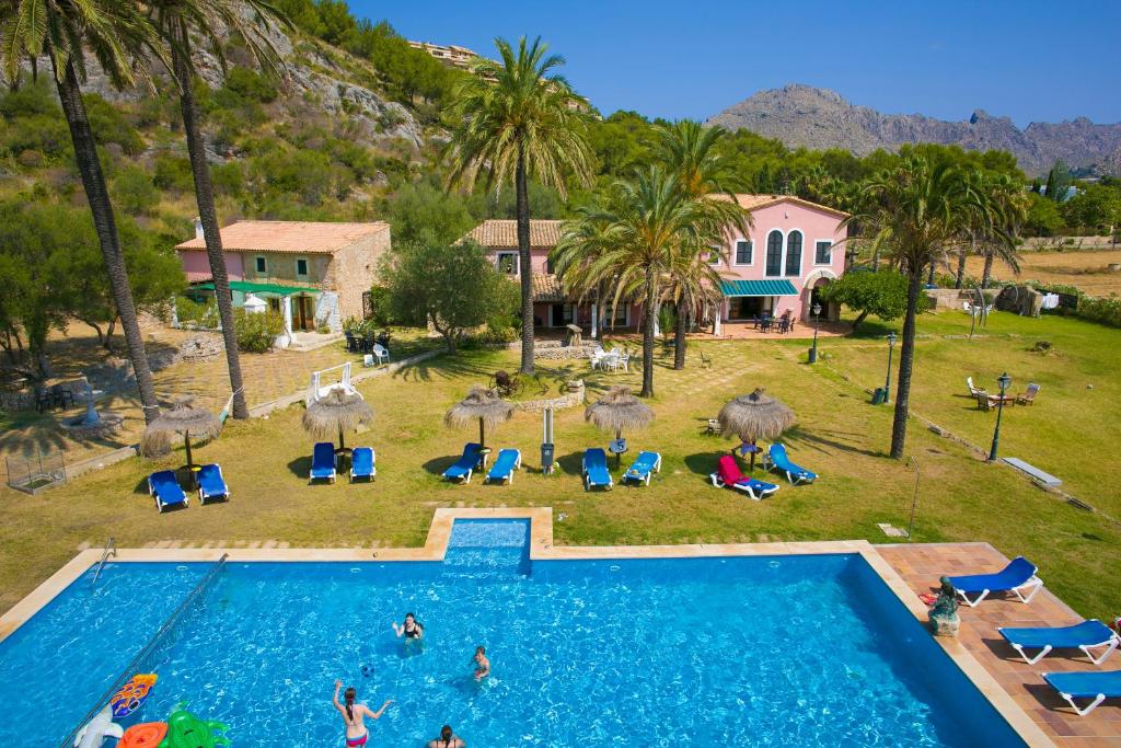 an aerial view of a swimming pool with people in a resort at Puerto de Pollensa cat Villas in Port de Pollensa