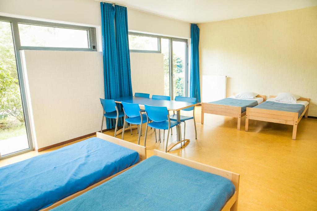 Postel nebo postele na pokoji v ubytování Jeugdherberg De Peerdevisser