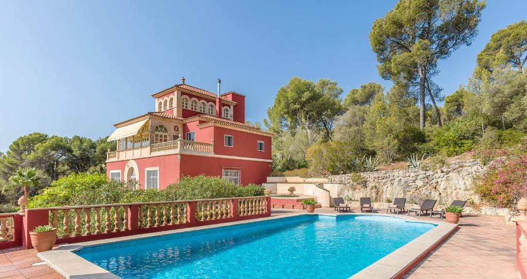 a house with a swimming pool in front of a building at Casa de las Vistas in Palma de Mallorca