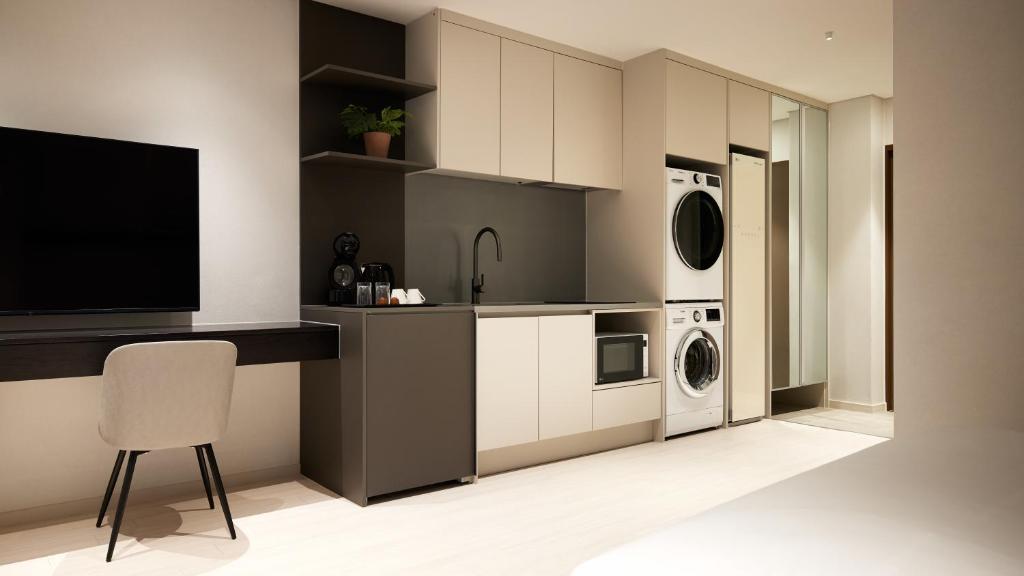 a kitchen with a sink and a counter with a tv at Yeouido Park Hotel in Seoul