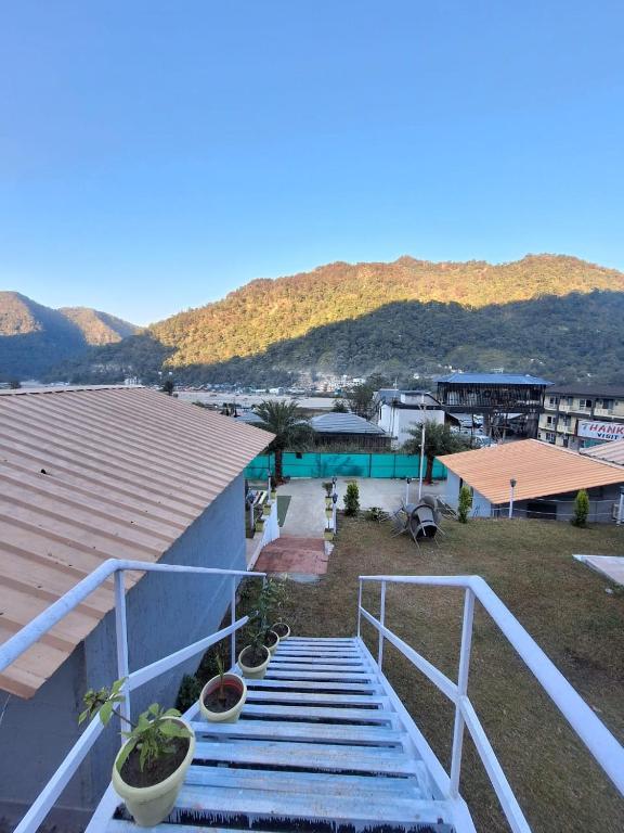a balcony with stairs and plants on a building at Valley King Resort in Rishīkesh