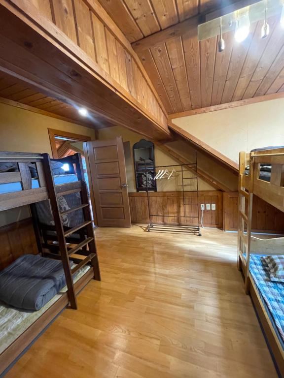 a room with several bunk beds in a house at 버킷 제주 - Bucket Jeju in Seogwipo