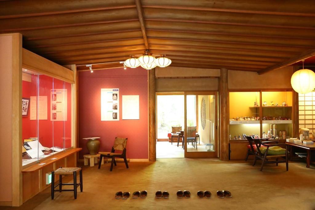 a room with shoes on the floor and a dining room at Yudanaka Yumoto in Yamanouchi