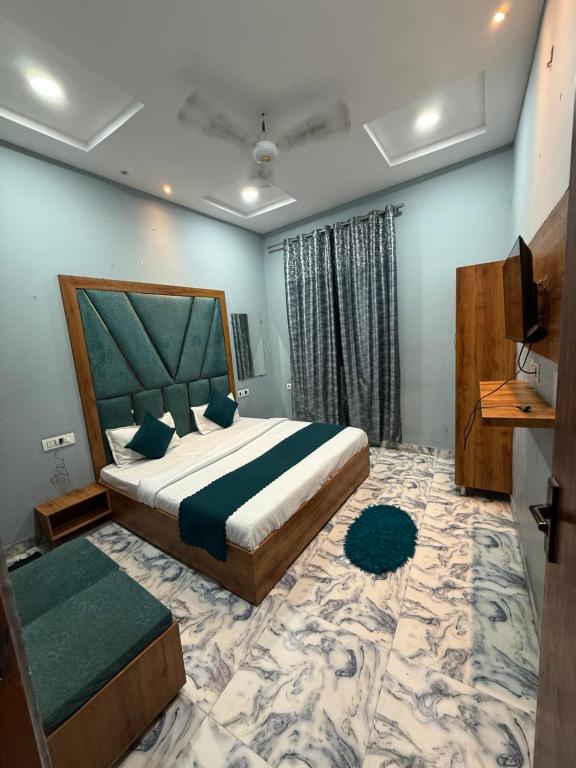 a bedroom with a king sized bed and a television at Sodhi Residency in Amritsar