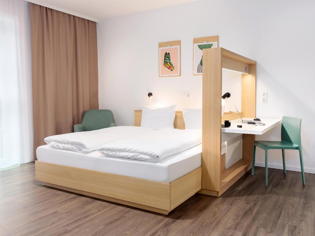 a bed in a room with a desk and a bed at smartments Hamburg Hamm in Hamburg