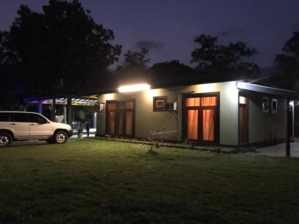 a small house with a car parked outside at night at Wewlekam Safari Resort 