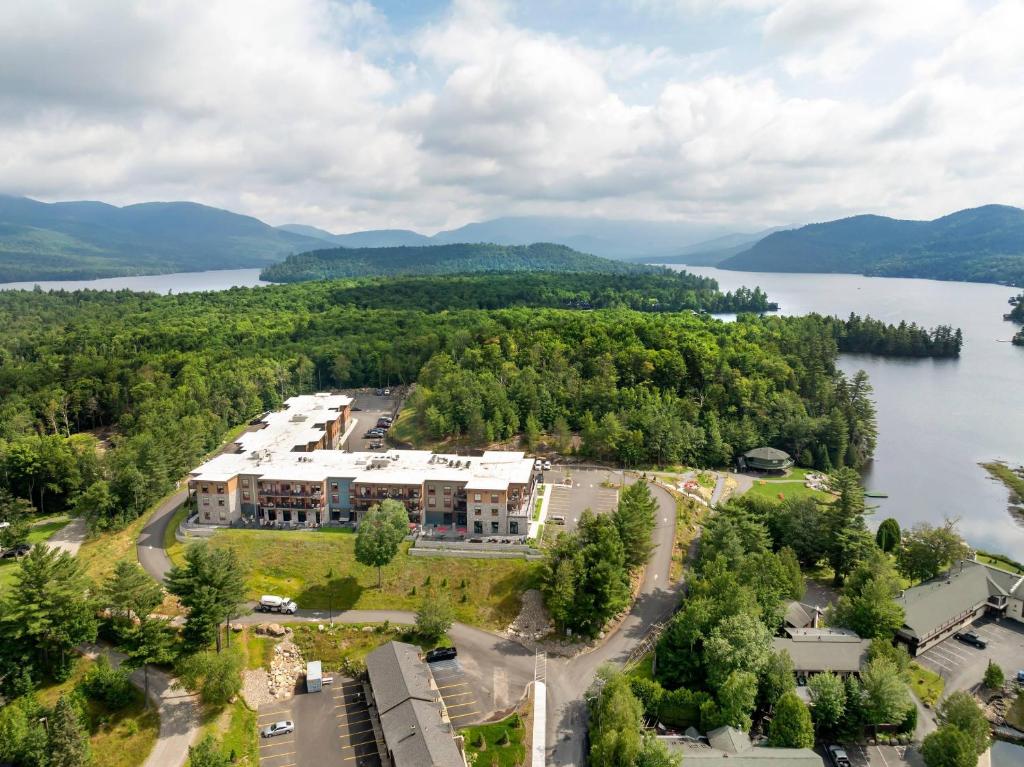 an aerial view of a building next to a lake at Cambria Hotel Lake Placid - Lakeside Resort in Lake Placid