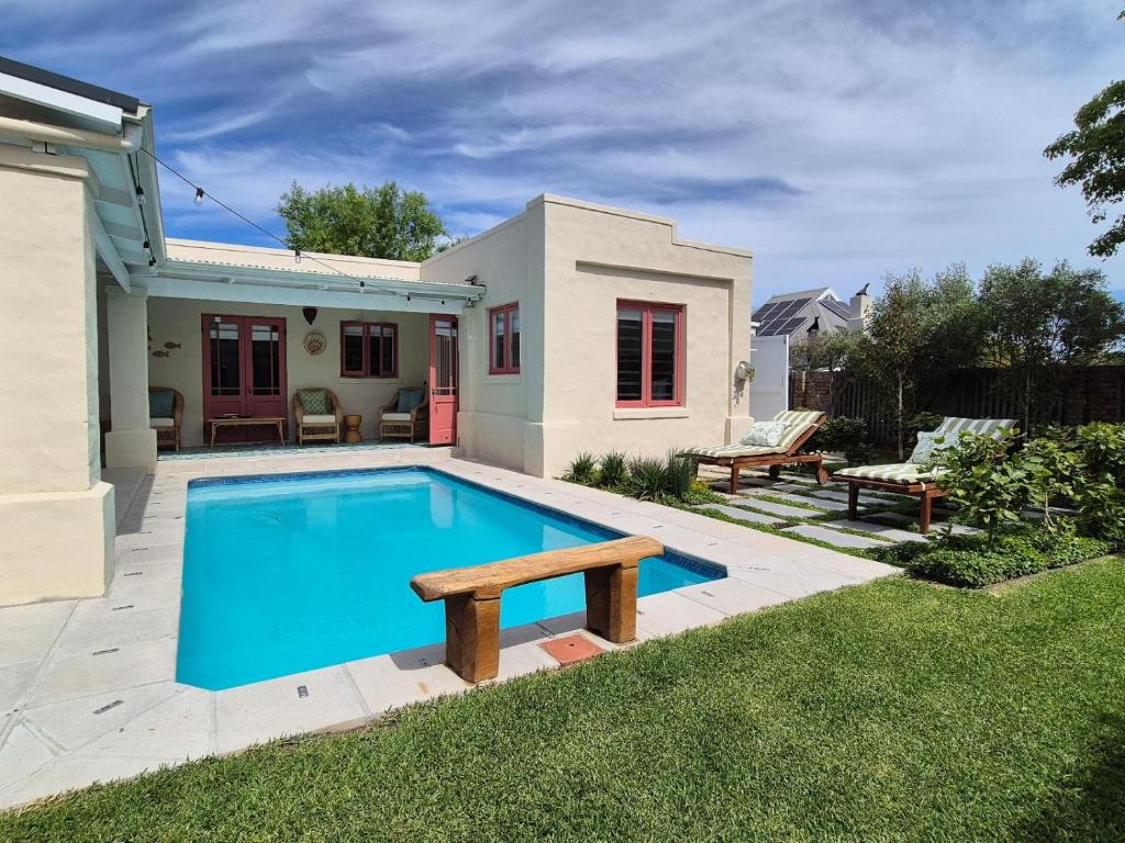 a swimming pool in the backyard of a house at Bramber cottage Stay a while in Stanford