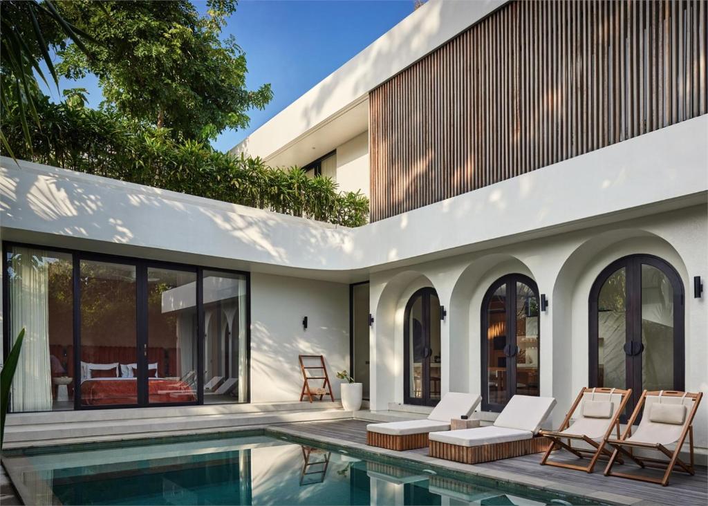 an external view of a house with a swimming pool at Lyvin Bingin Villas in Uluwatu