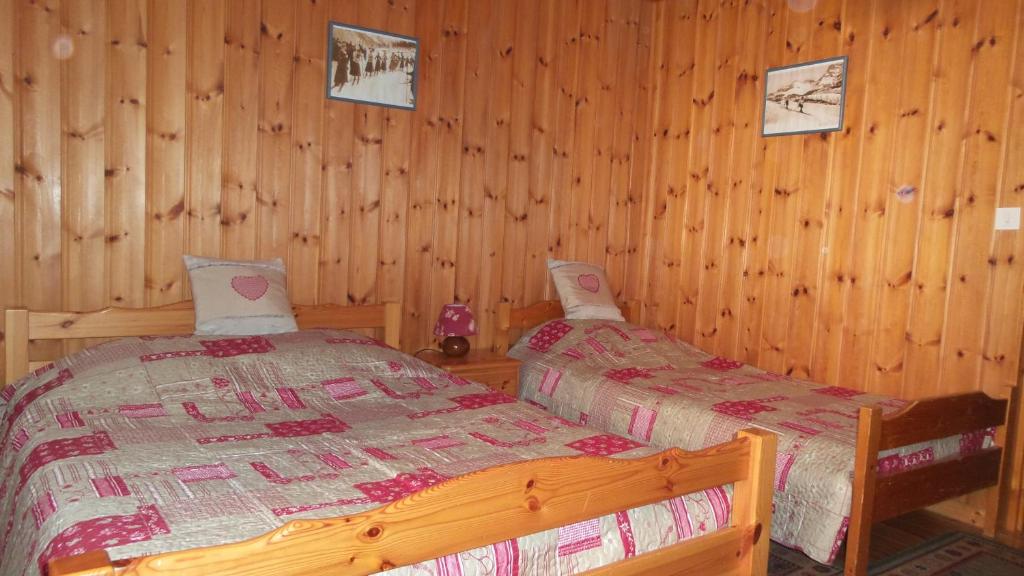 a bedroom with a bed in a log cabin at Chez Bernard & Chantal in Peisey-Nancroix