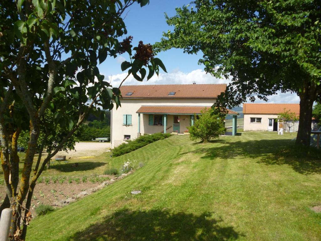 a house with a large yard in front of it at Chambre Saumon, La Prairie in Pourcharesse
