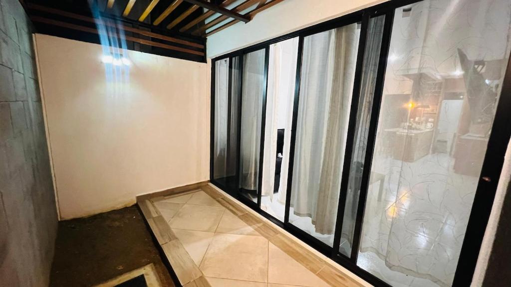 an empty room with a large window and a floor at New ground floor apartment, very comfortable and excellent location in Mazatlán