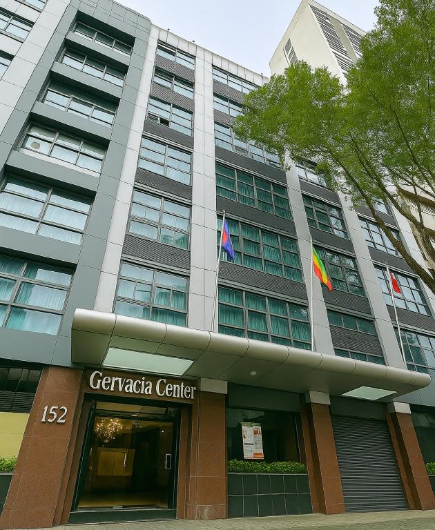 a building with two flags in front of it at Gervasia Hotel Makati in Manila
