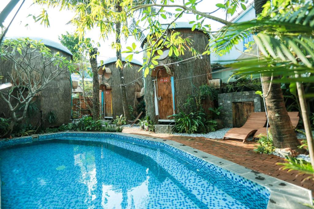 a swimming pool in the yard of a house at Cocohut Hoi An Homestay in Tân Thành (1)
