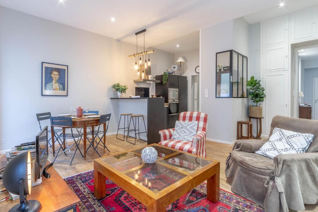 Le Barthou - T3 lumineux en centre-ville de Pau في بو: غرفة معيشة مع أريكة وطاولة
