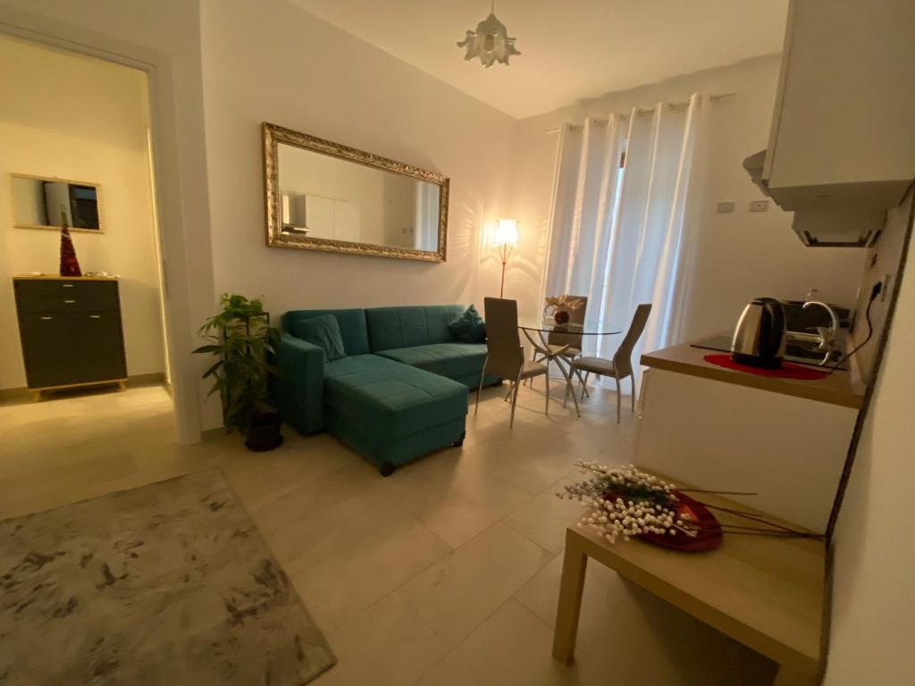 a living room with a blue couch and a table at Il Campanile 2 in Fondi