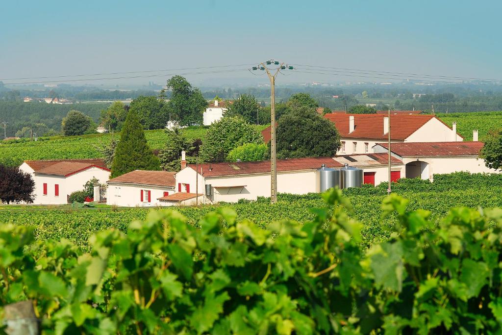a village in the middle of a field with houses at Domaine de la Chambre in Verrières
