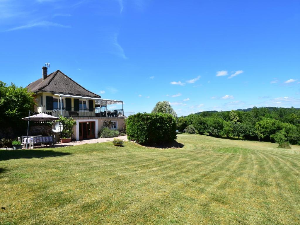 a house with a large lawn in front of it at Vacation Home in France with Pool in Chaumard