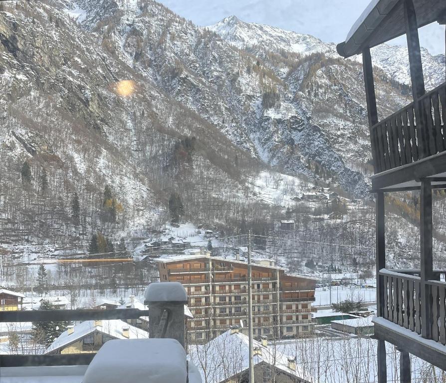 a mountain view from a balcony with snow covered mountains at Baita Trentin in Alagna Valsesia