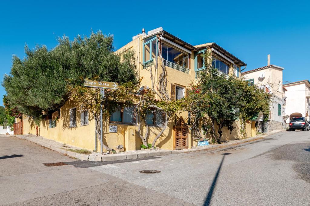 a yellow building on the side of a street at Chicca Di Francesca- Santa Teresa in Santa Teresa Gallura