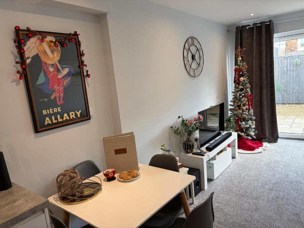 a living room with a table and a christmas tree at The Nook, Fairview, Cheltenham Town Centre-Parking & Garden in Cheltenham