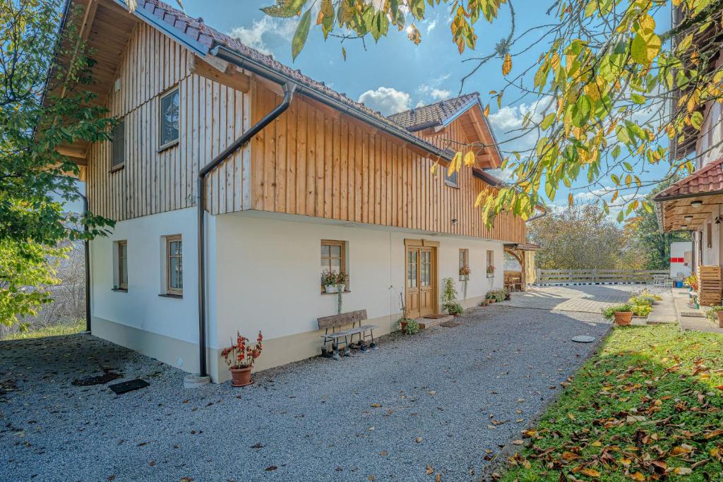 a building with a wooden roof and a street at Lukec Estate in Kostel