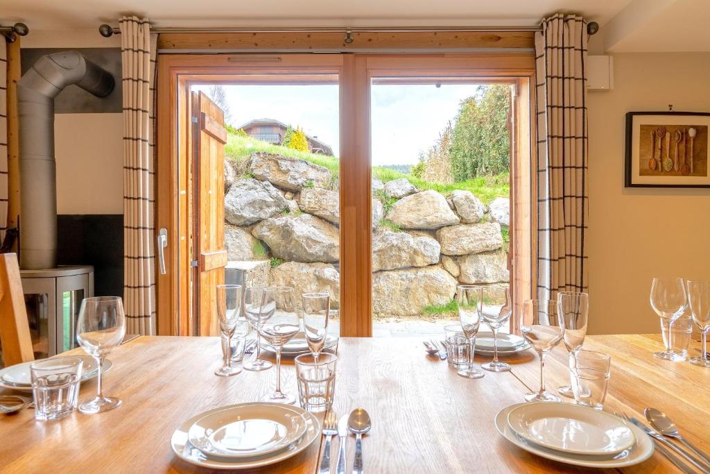 a table with wine glasses on top of it at ORTA Chalet in Les Gets