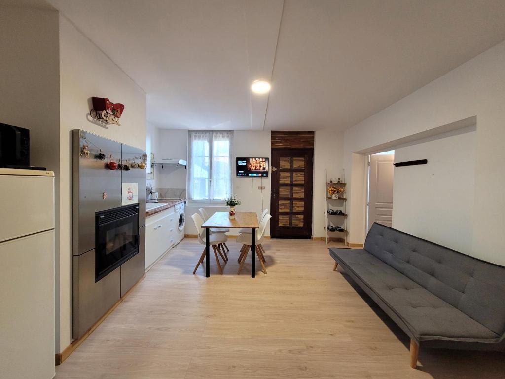 a living room with a couch and a table at Appartement entier au rez- de- chaussée 