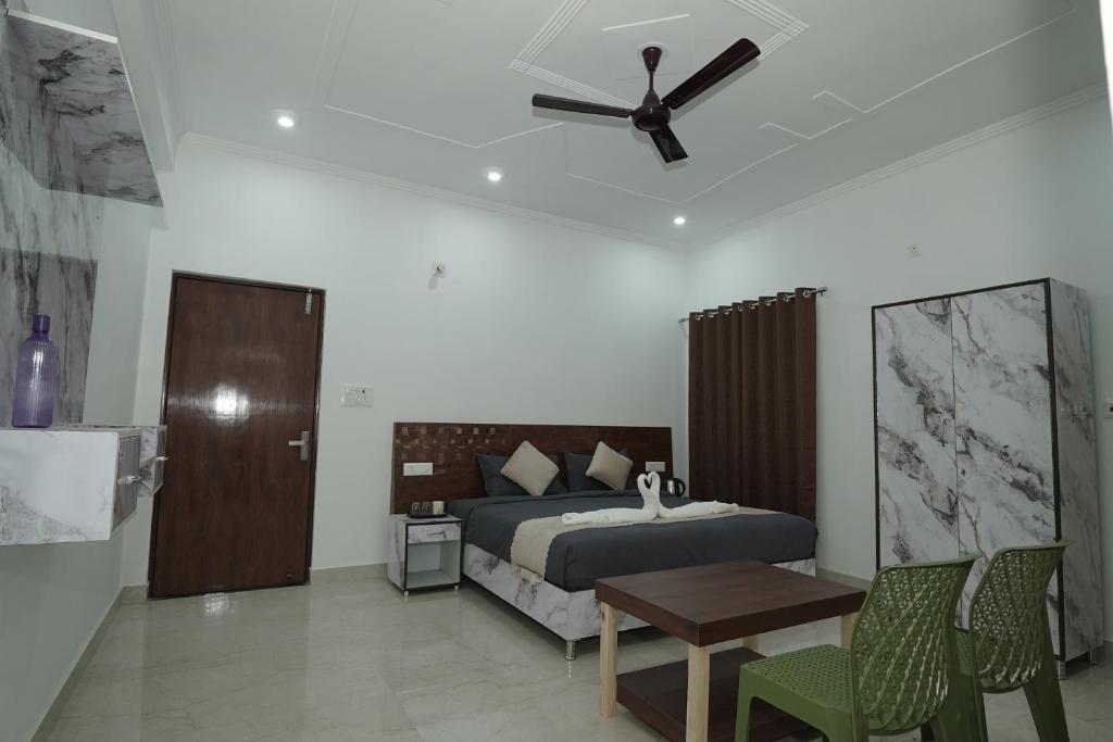 a bedroom with a bed and a ceiling fan at Taposthalam Sacred Retreat Hotel in Rishikesh in Rishīkesh