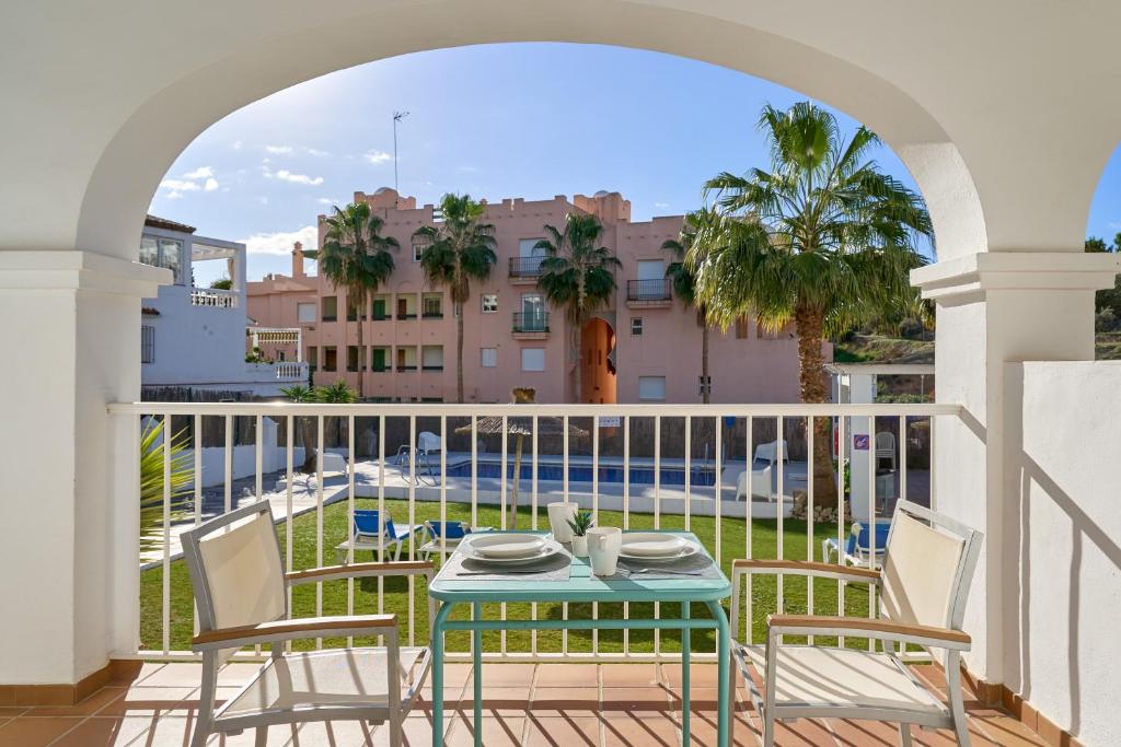 a patio with a table and chairs on a balcony at Apto 1 Almoraide Suites in Nerja
