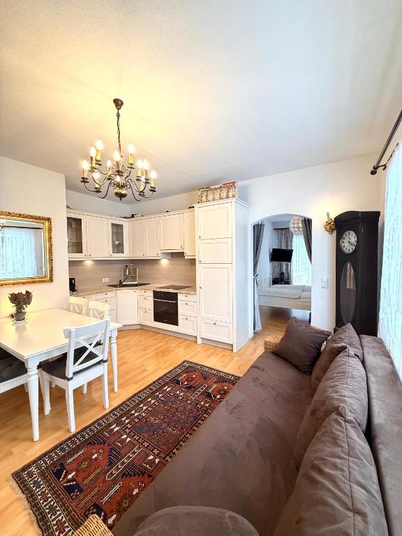 a living room and kitchen with a couch and a table at Traumhafte Wohnung auf Pferde Ranch in Aich