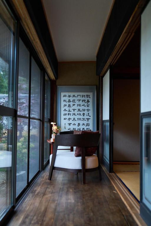 a room with a piano in a room with windows at 1日1組限定の宿 旅館 土と糸 Ryokan Tsuchi to Ito in Omi