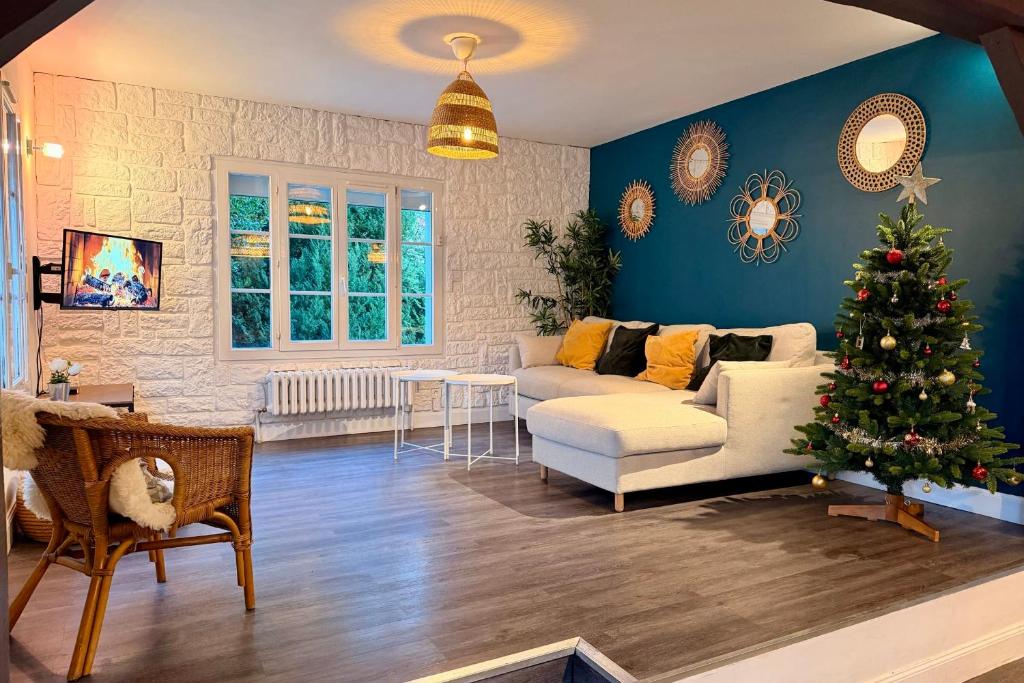 a living room with a christmas tree and a couch at Les Sablons in La Houssaye-en-Brie