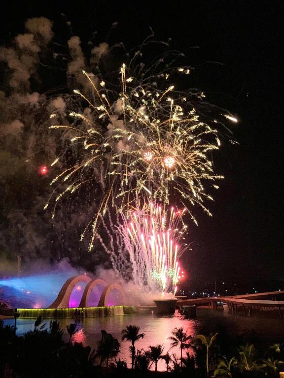 a fire show with fireworks exploding in the sky at The Room Hotel - Starbucks in Phú Quốc